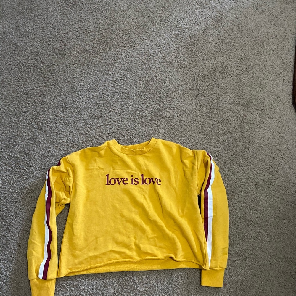 Yellow Crop top with the words "love is love"